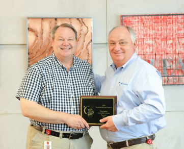 Alfa's President, Jimmy Parnell, and employee coordinator of Alfa's Relay for Life fundraising with plaque award